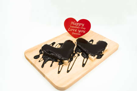Bread topped with chocolate and red hearts with text for Valentine's Day