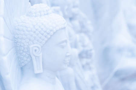 Buddha statue made of beautiful white limestone to be worshiped according to the faith.の写真素材