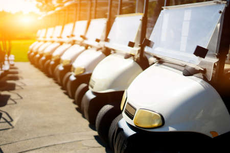 Golf carts line up in the golf course in the morningの写真素材