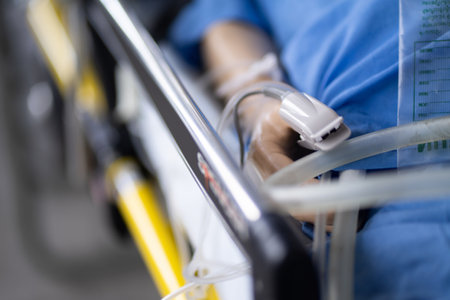 A patient measuring blood pressure on a bed at a hospital.の写真素材