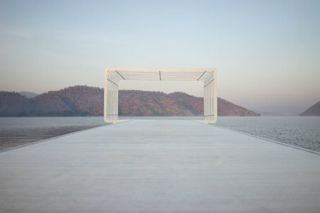 A large rectangular shape, a viewpoint of a resort with mountains and water surrounding it, slightly foggy.の写真素材