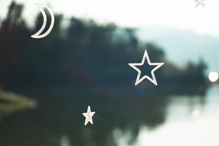 Stars and half moon float on bokeh light background.の写真素材
