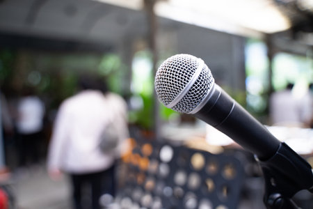 Microphone on abstract blurred image in seminar room or lighting in banquet hall speaking, event background.の写真素材