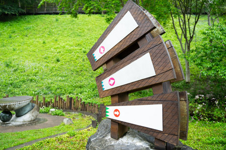 Wooden signposts with arrows pointing to different parts of the hotelの写真素材