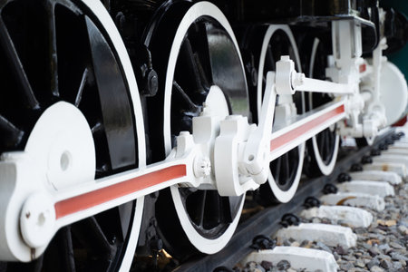 Side view of the lower shock The iron wheels of a steam locomotive on the tracks.の写真素材