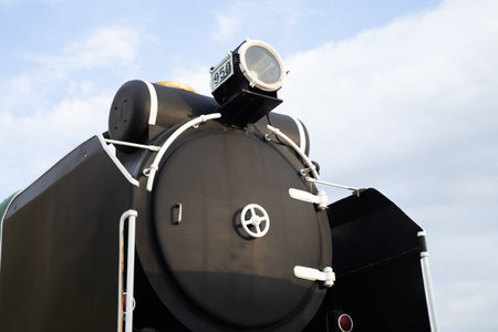 black steam locomotive bright sky background.