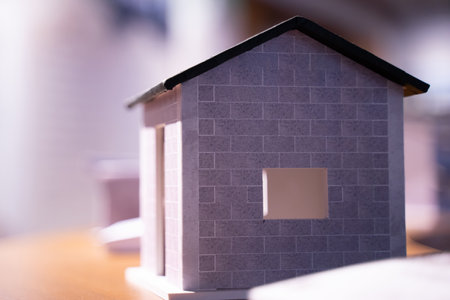 3D model of a solitary house under a tiled roof of a residential building. on bokeh light...