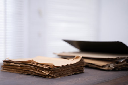 Old file folder with stacks of old and torn papers.