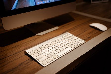 Computer keyboard and mouse placed on wooden table ready to use.の写真素材