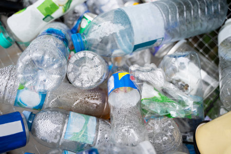 Plastic bottles in the recycling bin, waste management concept, stacked in bulk.