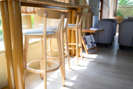 Wooden chair with white cushion in the living room of a minimalist room.の写真素材