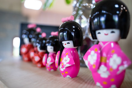 Cute, colorful Japanese-style ceramic dolls are lined up on the table to decorate your home.の写真素材