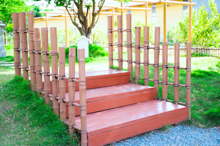 Wooden stairs with bamboo handles for minimalist garden decoration.
