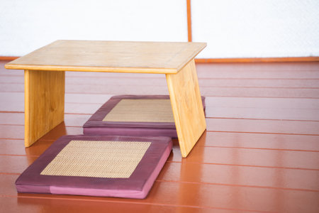 Wooden table with cushions in a Japanese style interior living room.の写真素材