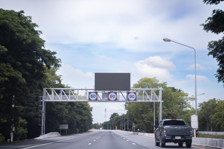 Road signs warn of average speed detection zones and speed limits for various types of vehicles.