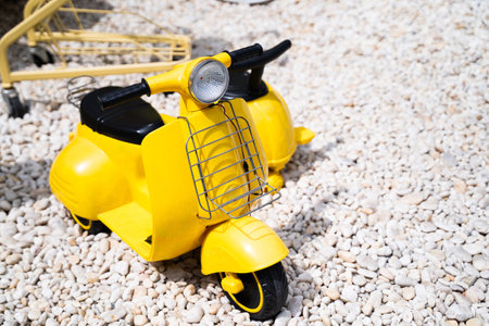 A classic yellow motorcycle sidecar is parked on a white gravel surface.の写真素材