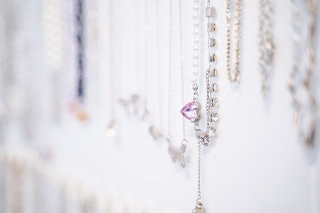 heart shaped jewelry necklace Fashion necklace hanging on a white wall.のeditorial素材
