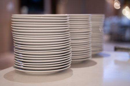 Many white dishes were placed on the table. In a coffee shop or restaurant.の写真素材