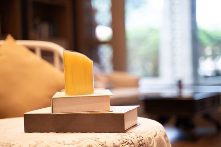 Candles placed on top of books in the living room of the house.の写真素材