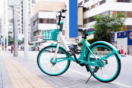 Beautiful pastel green bicycle parked on city street.の写真素材