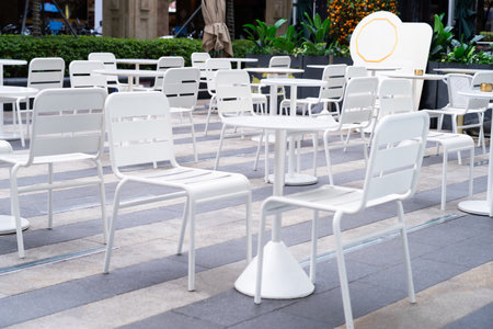 White dining table with chairs in a minimalist style shop. outdoor dining concept.