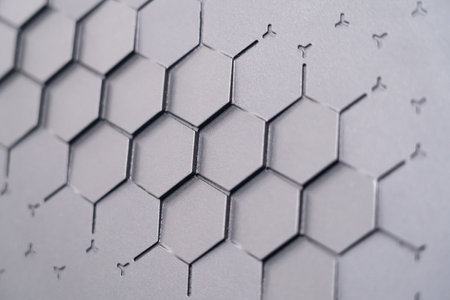 The background of the gray embossed wall texture has a geometric relief pattern.