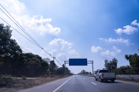 Blue empty road sign on the highway bright sky background.の写真素材