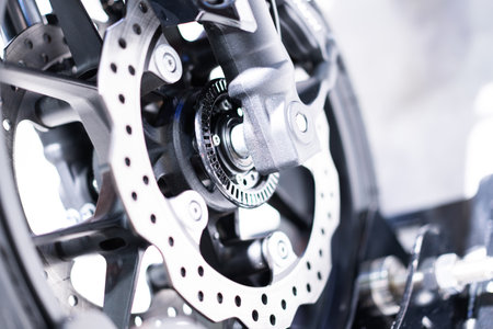 Close-up of motorcycle wheel components, metal sprockets, motorcycle shock absorbers.の写真素材