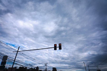 Traffic lights on dark blue sky background, big clouds, gloomy sky, stormy sky.