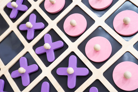 Close-up of XO, wooden board, XO game, psychology, small wooden toy, pastel colors.