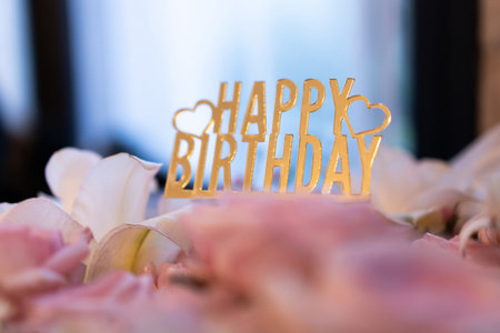 Close-up of happy birthday card on beautiful rose bouquet, bokeh light background.の写真素材
