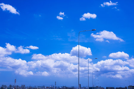 Sky background with white clouds on a clear day in the capital city.の写真素材