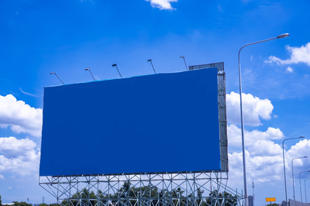 Large empty blue billboard on morning sky background.の写真素材