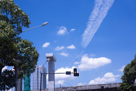 Traffic lights on sky background and white stripes on sky.の写真素材