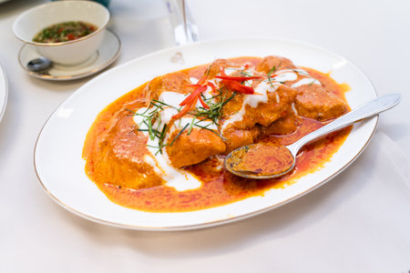 Thick Thai curry with stewed pork and herbs and spices isolated on white.の写真素材