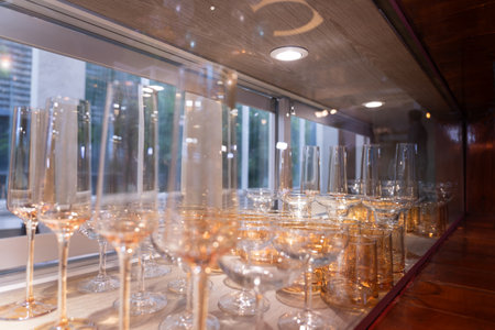 Many empty champagne glasses on a bar, on a blurred background.の写真素材
