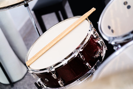 Drums with drumsticks, focus on specific points in the studio.の写真素材