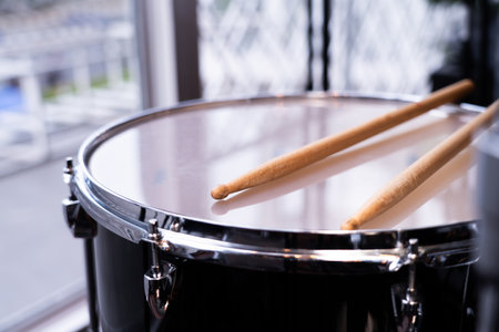 Drums with drumsticks, focus on specific points in the studio.の写真素材