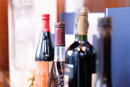 Old wine bottles are lined up on the table for tonight's party.の写真素材