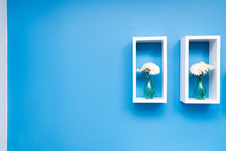 Flower vase on a blue wall.の写真素材