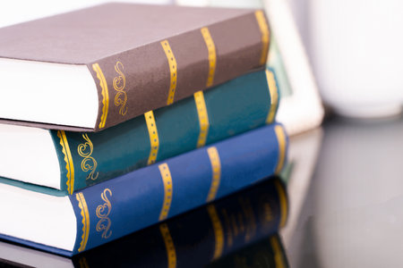 Stack of old books isolated on bokeh light background.の写真素材