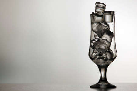 Detail of a glass filled with ice on a light backgroundの写真素材