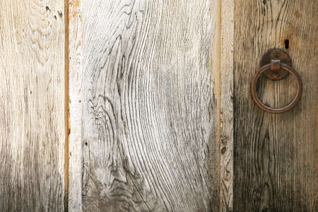 Detail with the handle of an old wooden doorの写真素材