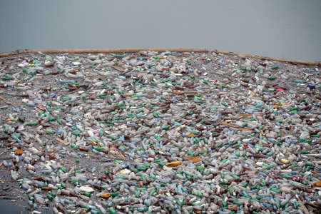 Bicaz, Romania - July 12, 2011: Lots of plastic bottles float on lake Bicaz's surface in Romania.のeditorial素材