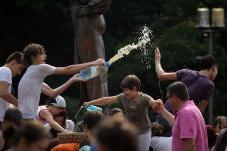 Bucharest, Romania - June 18, 2011: Children and teenagers play with water on a sunny day in a park in Bucharest, Romania.のeditorial素材