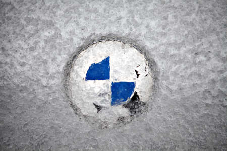 Bucharest, Romania - February 5, 2012: Picture of the BMW logo covered with ice. Founded in 1917,...