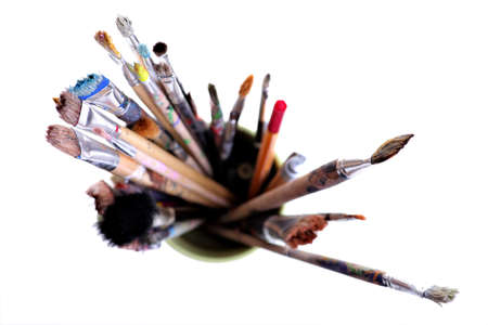 Various dirty paint brushes in a jar with shallow depth of fieldの写真素材