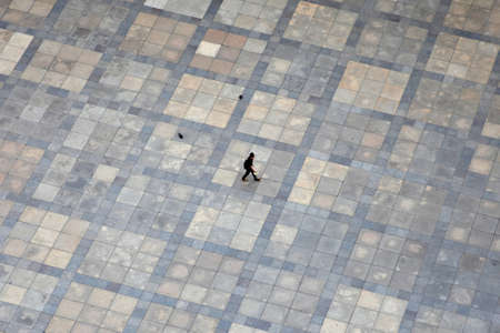 Prague, Czech Republic - July 3, 2012: A lonely tourist is pictured from above while traversing the square in front of St.Vitus Cathedral in Prague, Czech Republic.のeditorial素材