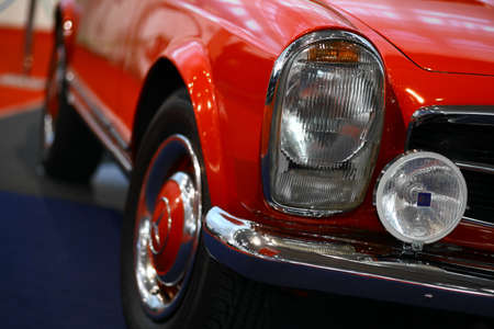 Bucharest, Romania - October 22, 2012: Detail of a red painted Mercedes Benz 230 SL at a car show in Bucharest. Mercedes-Benz is a division of the German automobile manufacturer Daimler AG.のeditorial素材