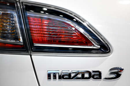 Bucharest, Romania - October 22, 2012: Mazda 3 logo is displayed on a car in Bucharest. Mazda Motor Corporation is a Japanese automotive manufacturer.のeditorial素材